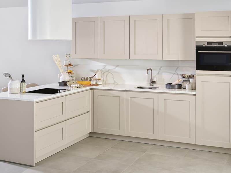 Beige-hoekkeuken-met-bar-en-kaderfronten